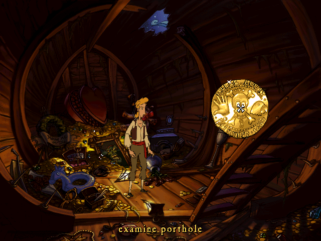 a screenshot from Curse of Monkey Island that looks like an interactive cartoon, showing the pirate protagonist exploring a ship’s hold full of treasure. The interface is displayed as a pop-up of a gold doubloon, with exaggerated icons for a hand, a skull with eyes, and a parrot head.