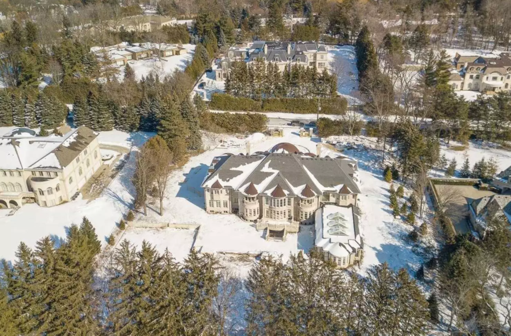 Aerial photo of several giant mansions on smallish square lots.